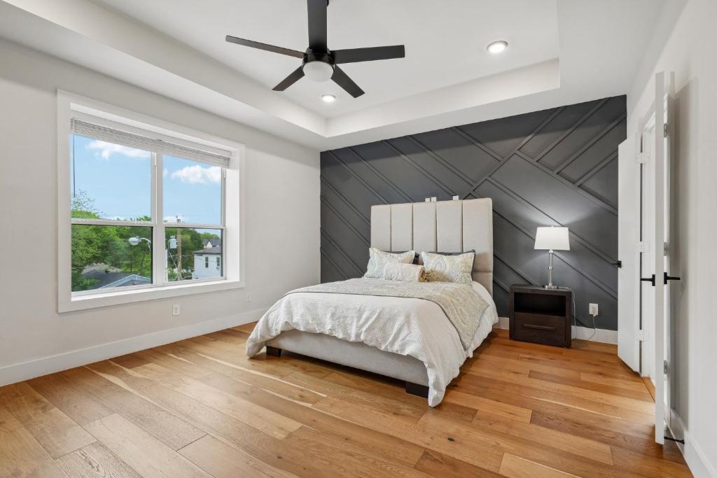 a bedroom with a bed and a ceiling fan at Munice at Trinity Grove in Dallas