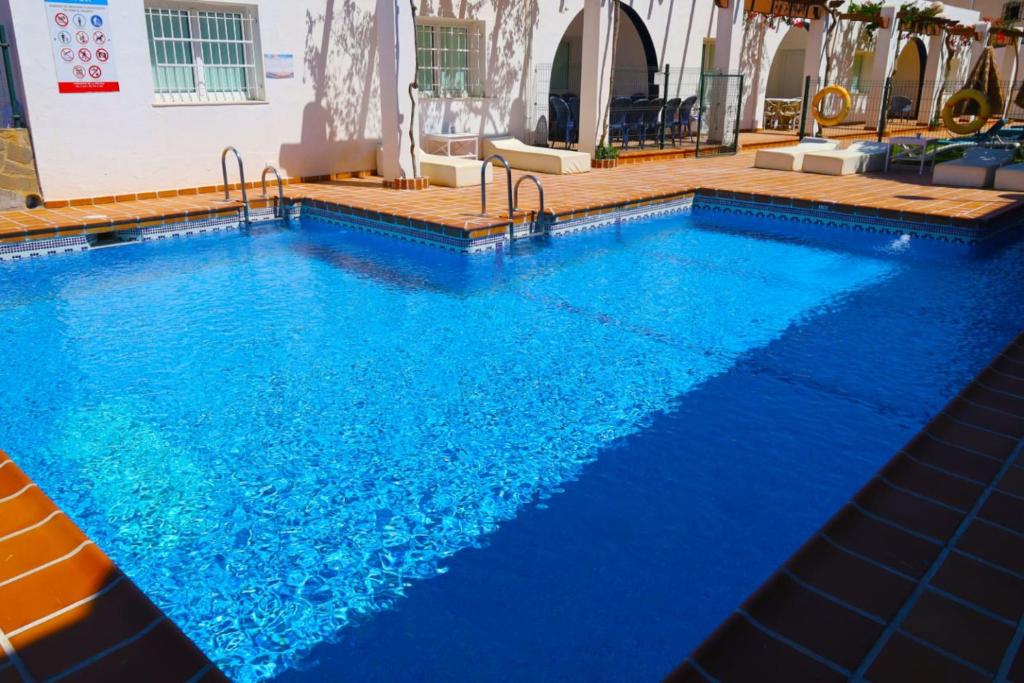 a large swimming pool with blue water at Hotel Marazul in Mojácar