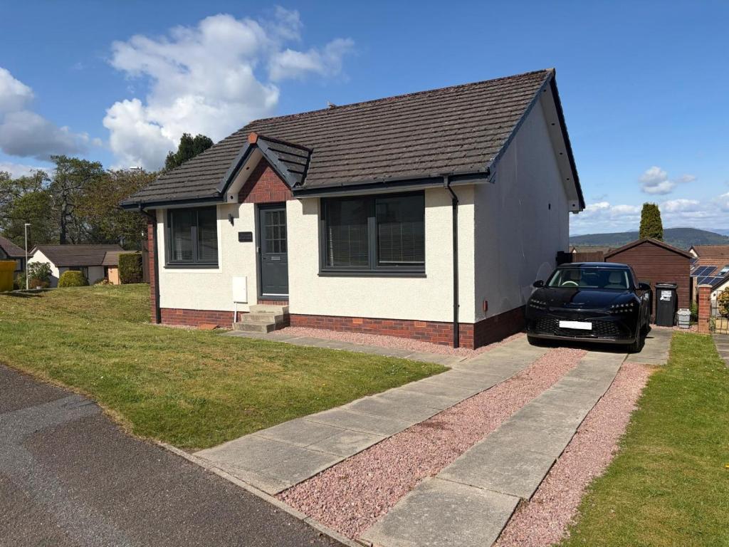a car parked in front of a house at Firth View Heights, Luxury Detached Cottage with Stunning Panoramic View in Inverness