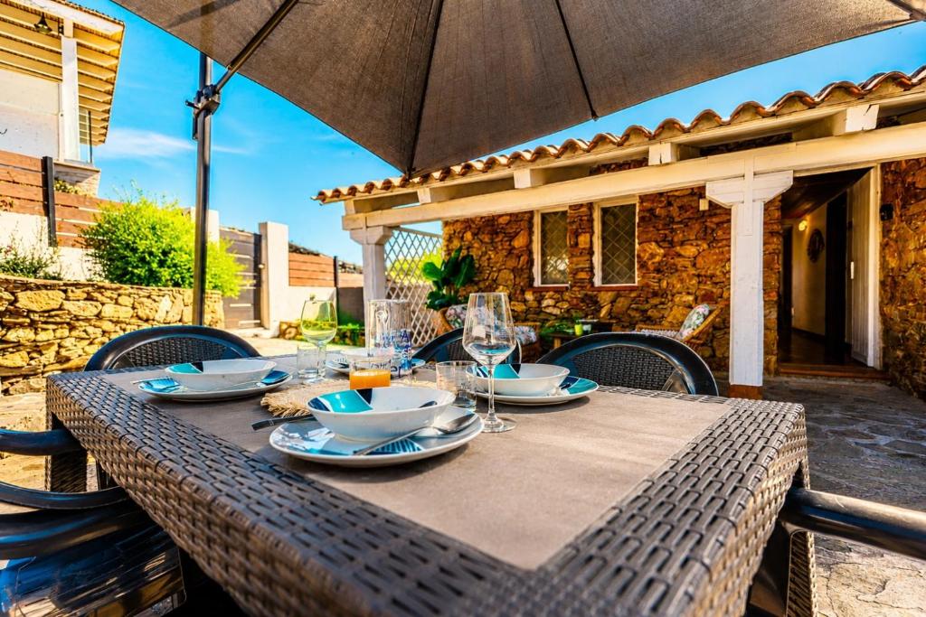 a table with an umbrella on a patio at ALBA - Seaview Luxury in San Teodoro