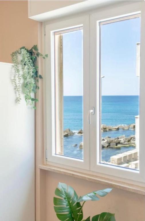 a window with a view of the ocean at RossoCorallo in Gallipoli
