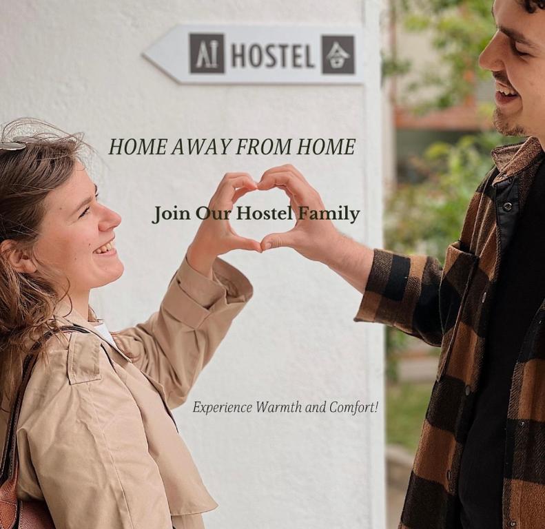 a man and a woman making a heart with their hands at AI HOSTEL in Split
