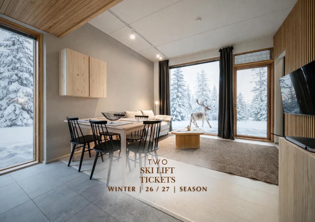 a kitchen and dining room with a table and chairs at Aurora Gielas B5 Ski-in Ski-out, Mountain View by Aavalevi in Levi
