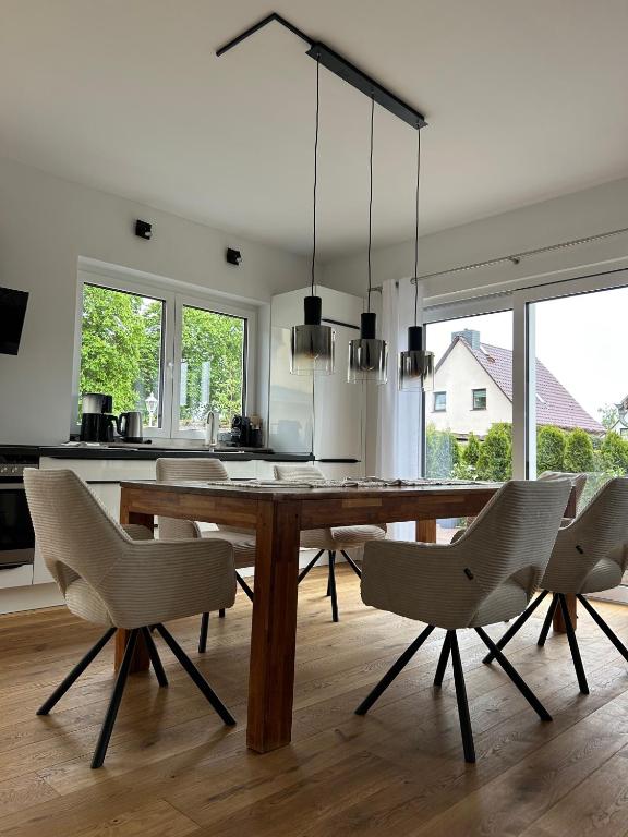 a dining room with a wooden table and chairs at Haus am Meer mit Sauna in Koserow in Koserow