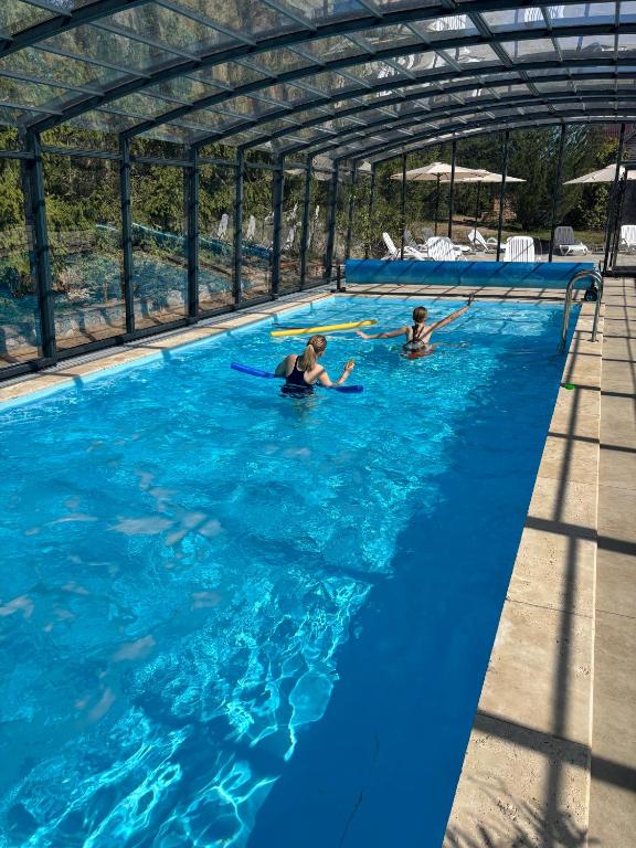 two people are in a swimming pool at Port Jabłonka in Jabłonka