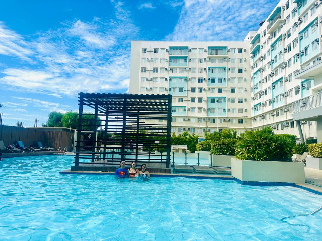 two people in a swimming pool in a building at Norman Condominium Unit Rental in Dumaguete