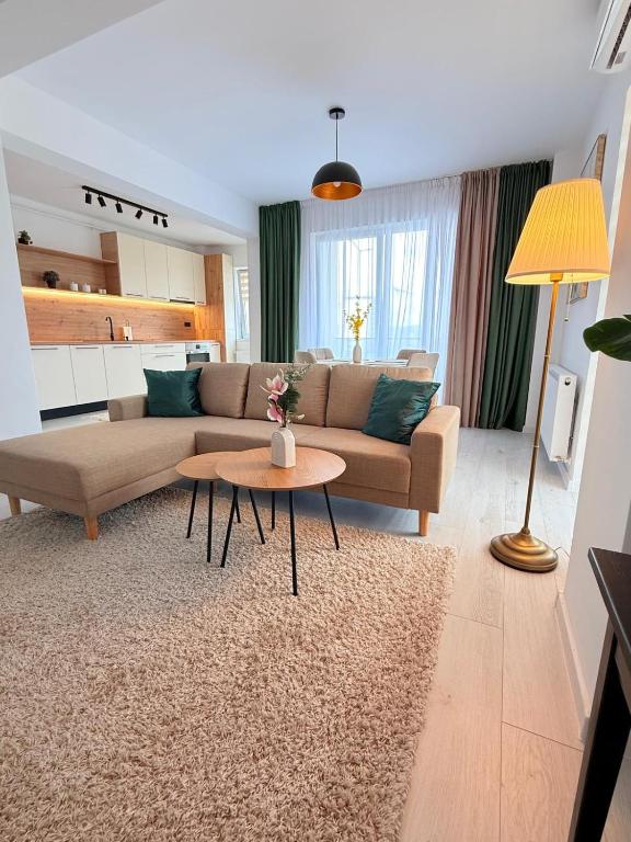 a living room with a couch and a table at Apartament Luna in Şelimbăr