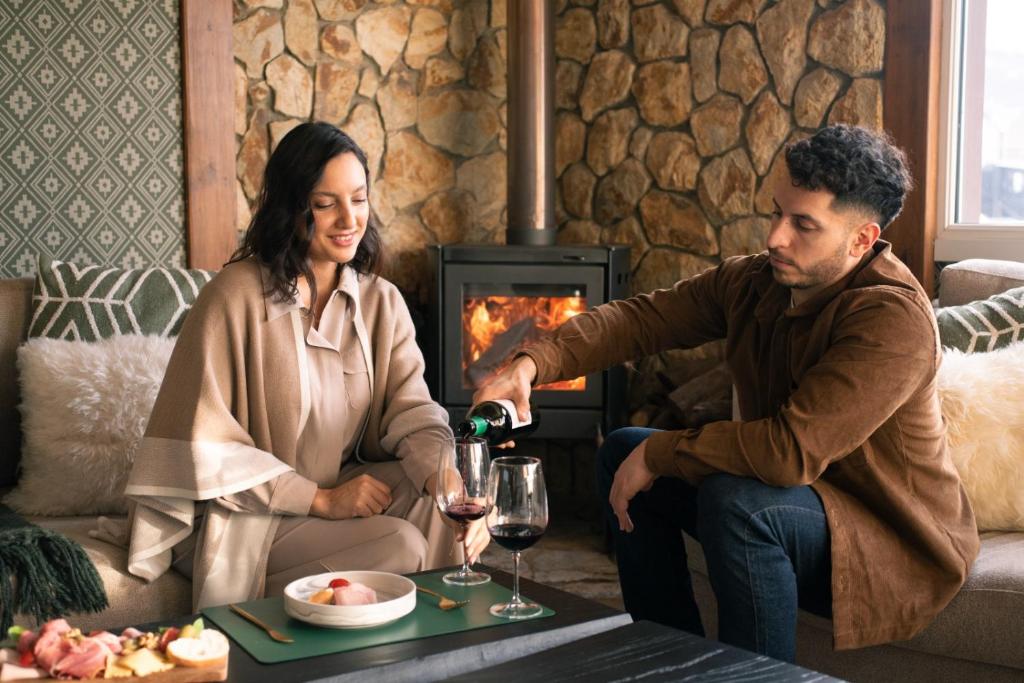a man pouring a woman a glass of wine at Lennox Ushuaia in Ushuaia
