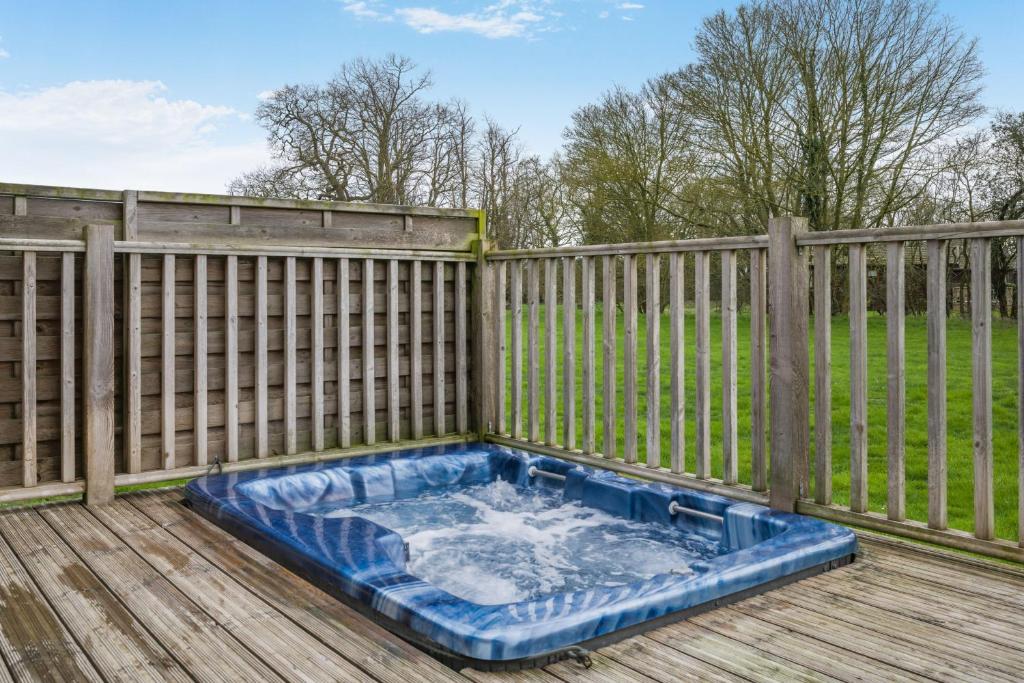 a hot tub on a deck with a fence at Primrose 1 bed-No Pets-Lily in Eye