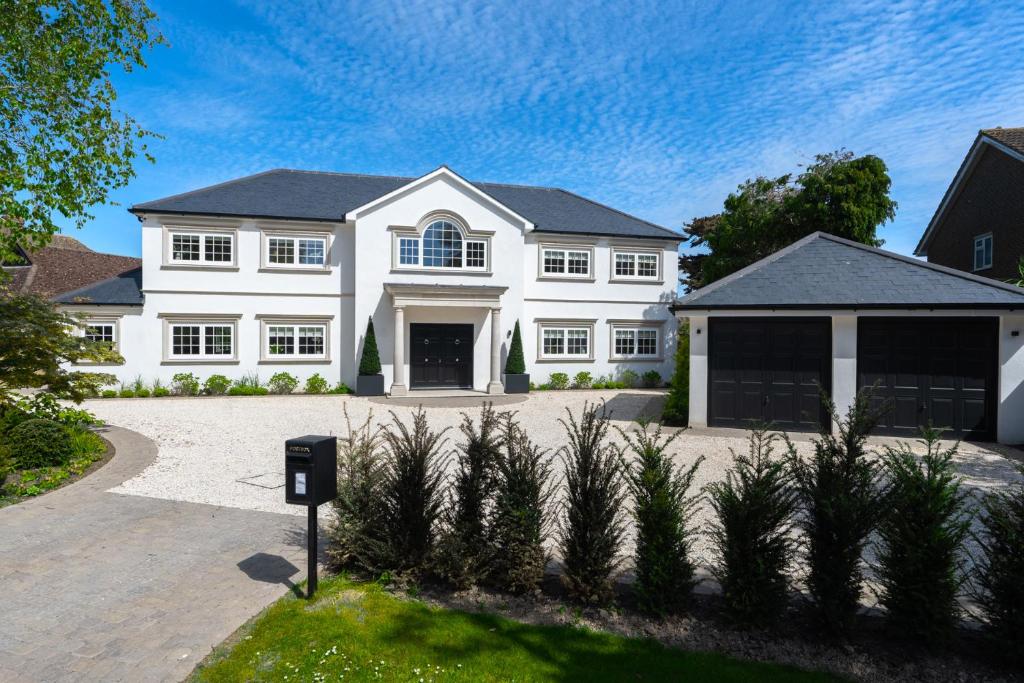 a large white house with a driveway at Sea Estate House in Littlehampton