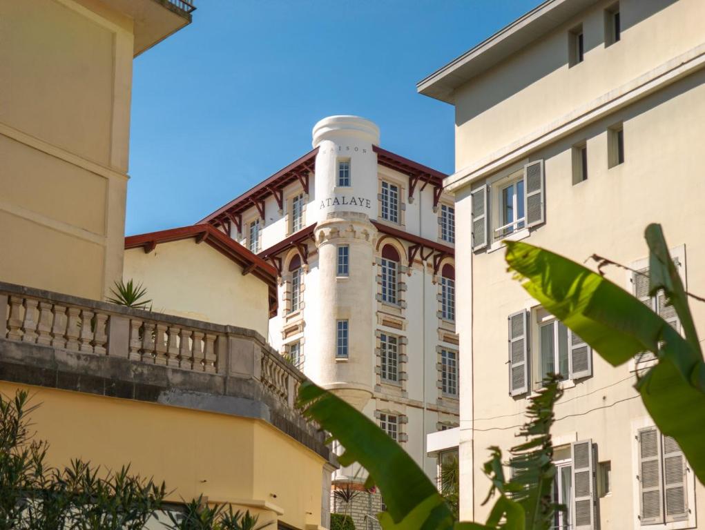 a building with a clock tower on top of it at Maison Atalaye - Hôtel entièrement rénové in Biarritz