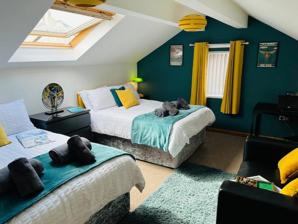 a bedroom with two beds with stuffed animals on them at Scarisbrick Apartment Sleeps 6 in Scarisbrick
