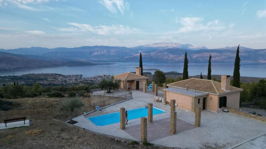 an external view of a villa with a swimming pool at Olive House Galaxidi in Galaxidi