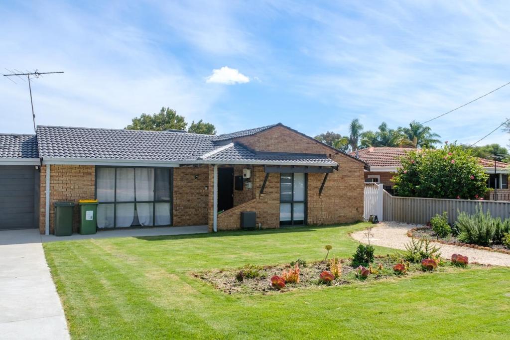 a brick house with a yard at 3-Bed home with large backyard in Mandurah