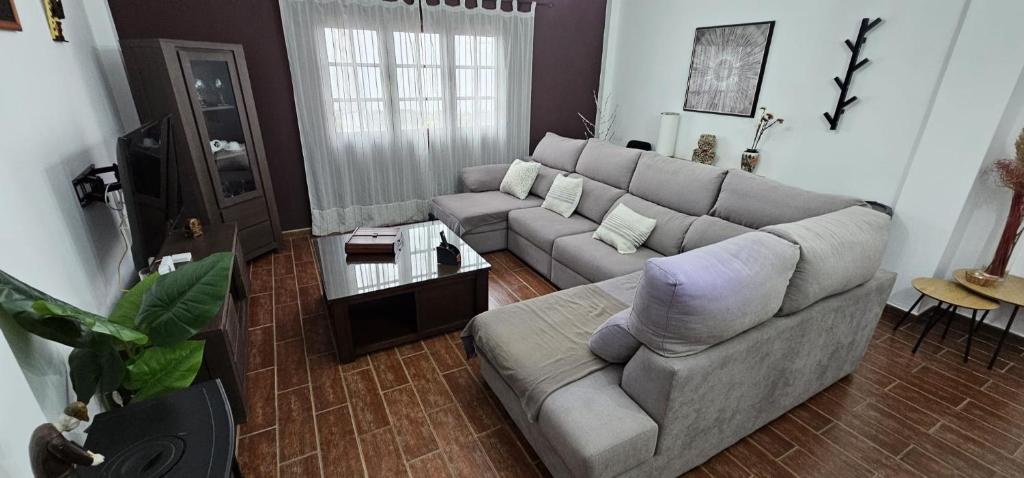 a living room with a couch and a table at Casa V del Pino in Teror