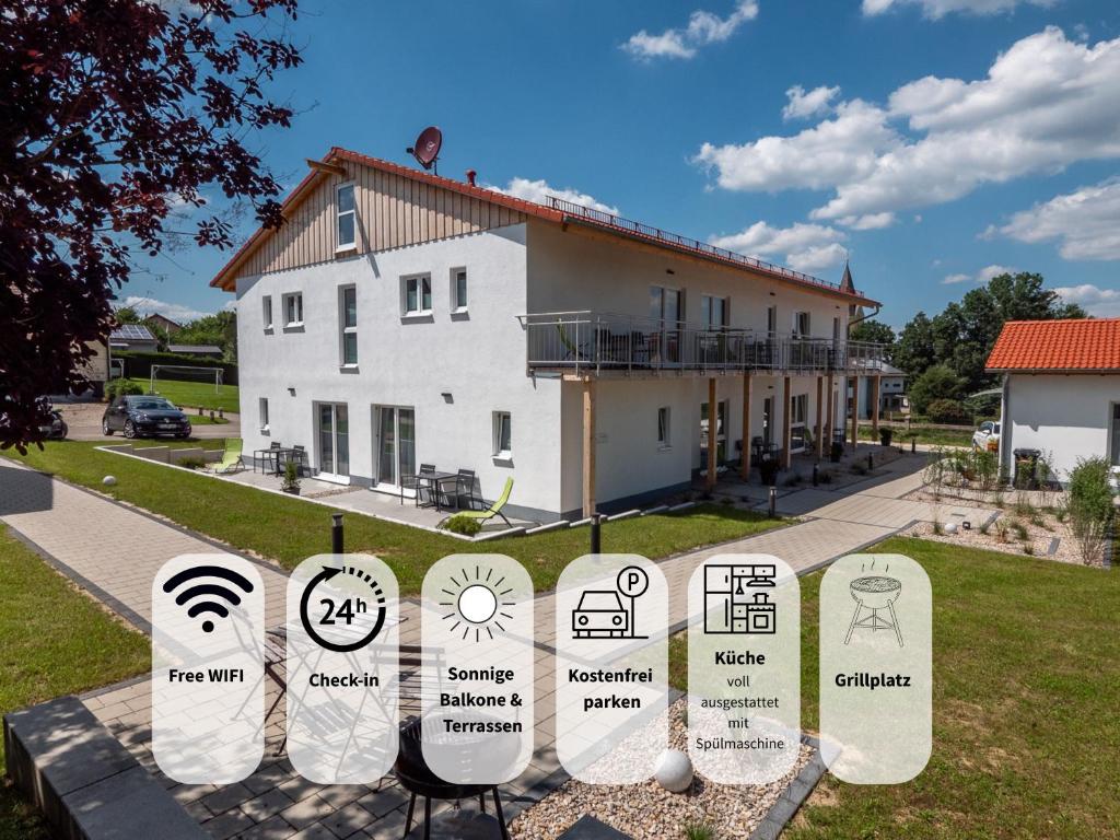 a white building with signs in front of it at Holledau-Apartments - Auszeit im schönen Hopfenland in Bayern - voll ausgestattete Apartments - Garten - Balkon - Nähe München in Osterwaal