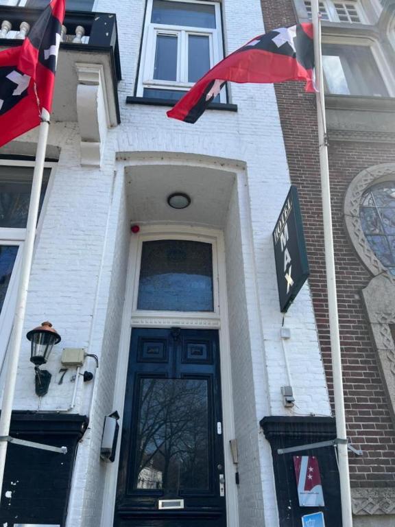 a building with two flags in front of a door at MAX Hotel Amsterdam in Amsterdam