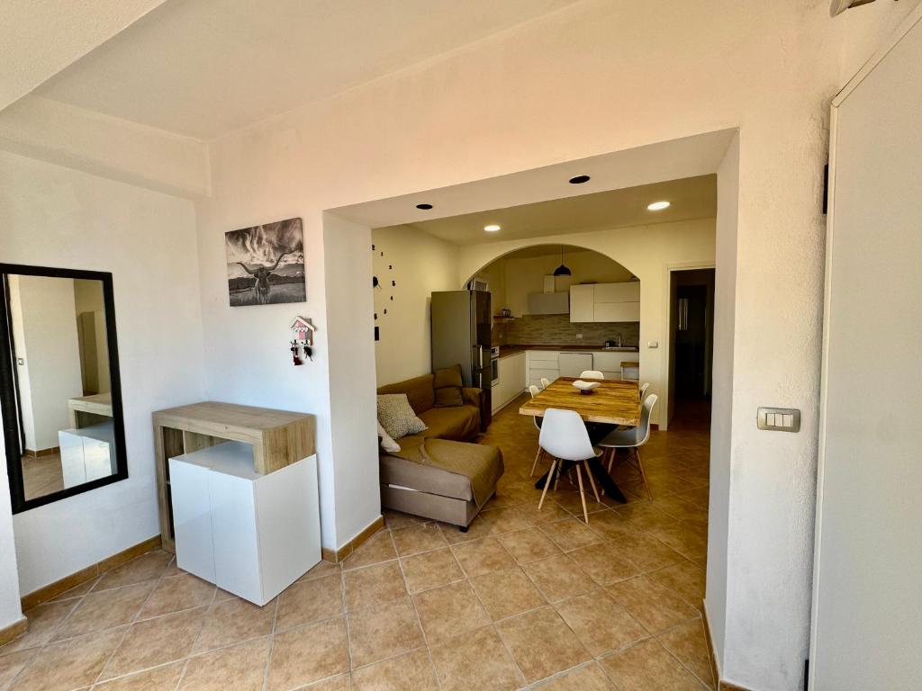 a kitchen and a living room with a table at Casa via veneto in Carbonia