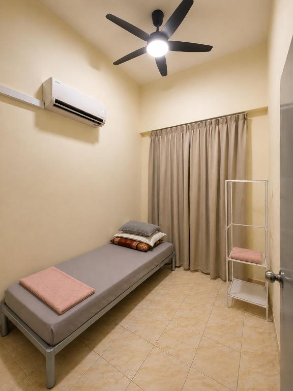 a room with a bed and a ceiling fan at TBSC by Reemon in Keningau