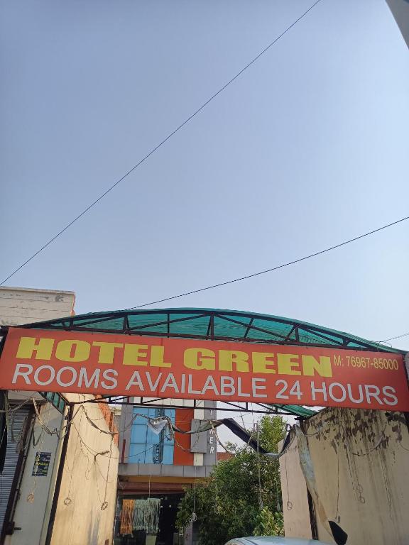 a hotel green rooms available hours sign in front of a building at Hotel Green in Bhucho