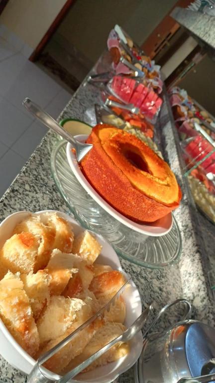 two plates of food sitting on a table at Hotel CANTO DA SERRA in Caldas Novas