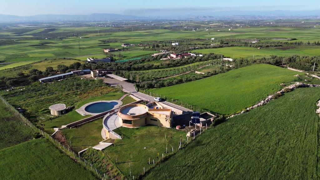 an aerial view of a house in a green field at Bhalil Farm House in Sefrou