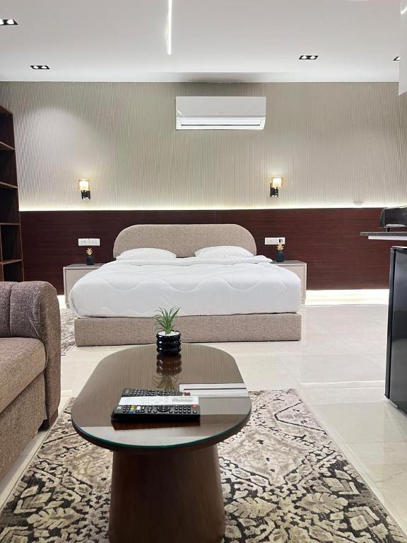 a bedroom with a bed and a table and a couch at Regal View Residences & Suites in Cairo