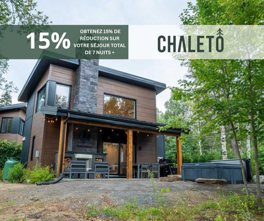 a house with a sign that reads chilko at Spa et River - Le Grand-Pic in Saint-Alexis-des-Monts