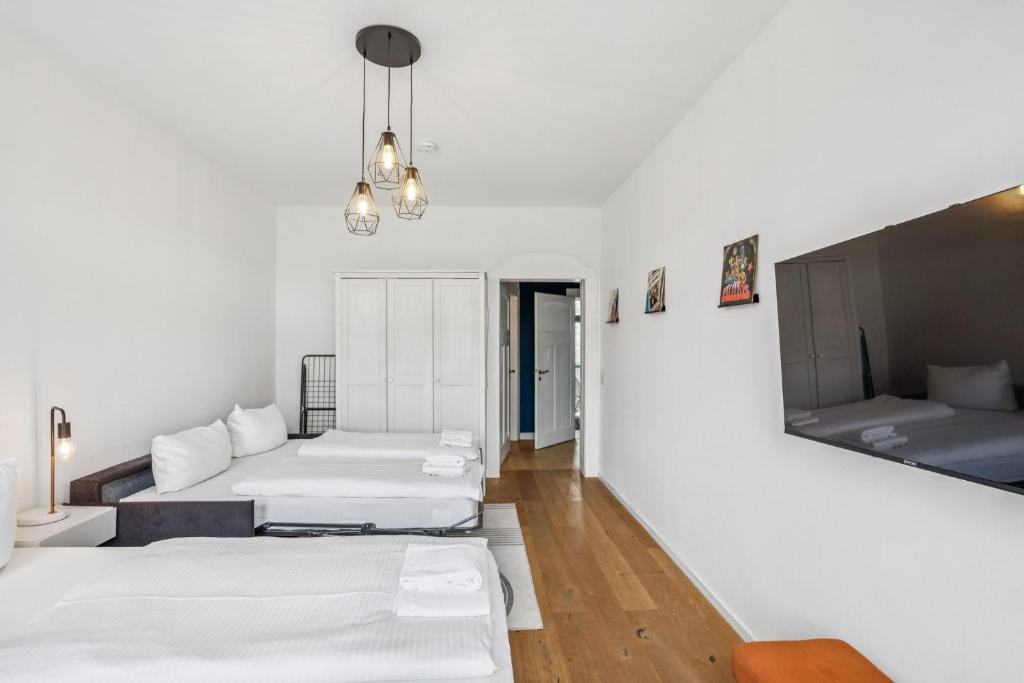 a room with two beds and a flat screen tv at Arbio I Modern Apart near Leipzig Stötteritz in Leipzig