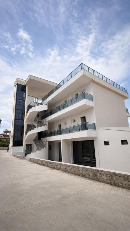 a large white building with balconies on it at Zador Hotel in Ksamil