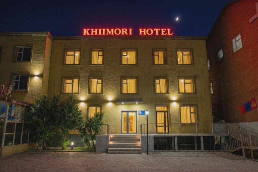 a hotel with a red sign on top of it at Khiimori Hotel in Ulaanbaatar