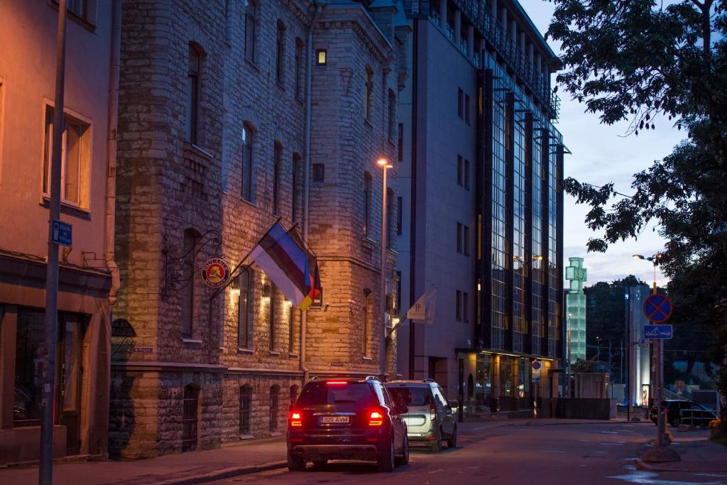 a car parked on a street in front of a building at Hotel St. Barbara in Tallinn