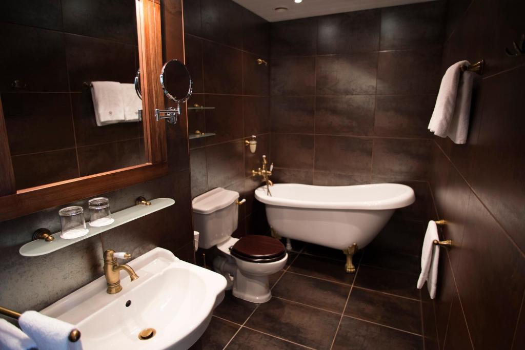 a bathroom with a sink and a toilet and a sink at Hotel St. Barbara in Tallinn