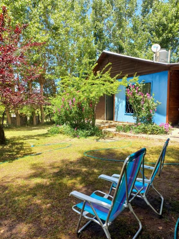 two chairs and a table in front of a house at La Blau in Mendoza