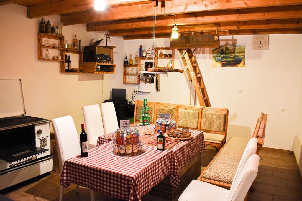 a dining room with a table with a red and white checkered table cloth at Konoba Oklop in Tomislavgrad