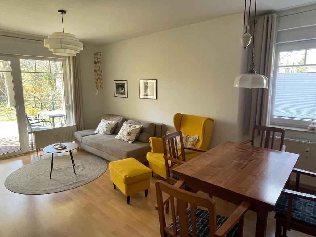 a living room with a couch and a table at Ferienwohnung H 25 "Tausendschön" in Graal-Müritz