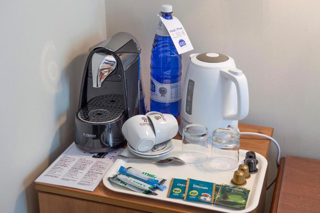 a table with a coffee maker on top of it at Hotel St. Barbara in Tallinn