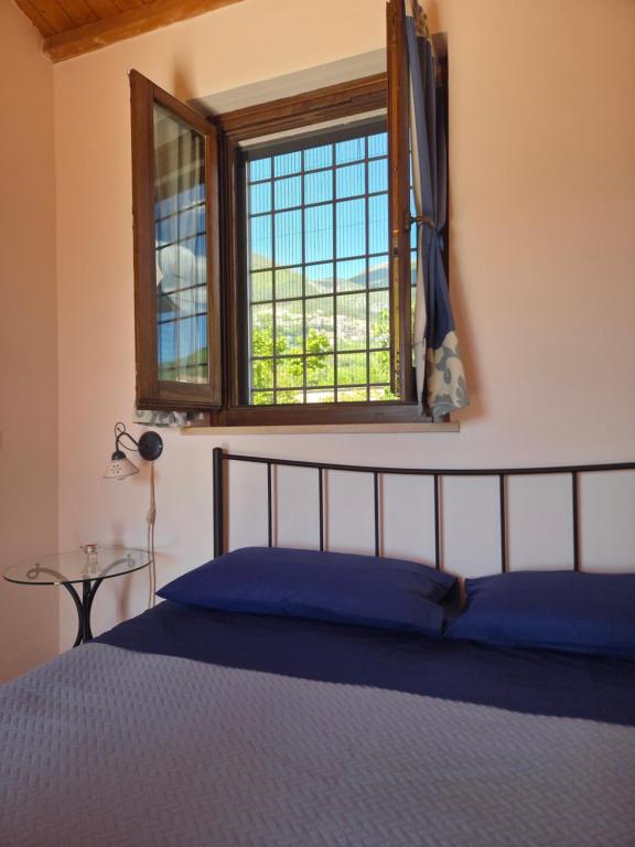a bedroom with a bed and a window at Volo Libero - Guest House in Poggio Bustone