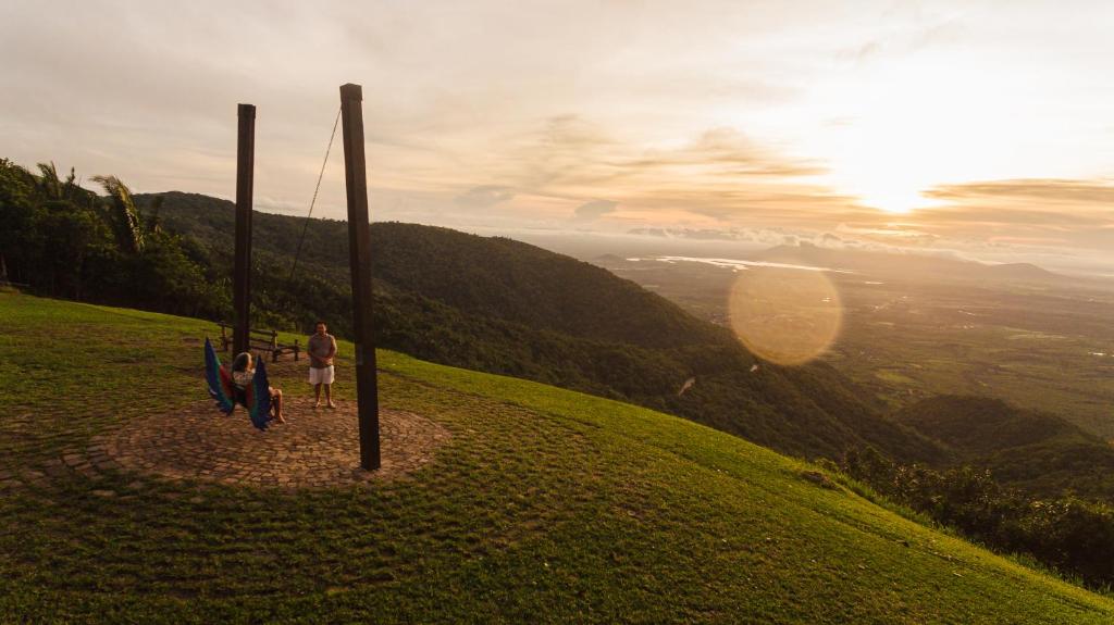 a couple of people standing on top of a hill at Sítio do Bosco Park in Tianguá