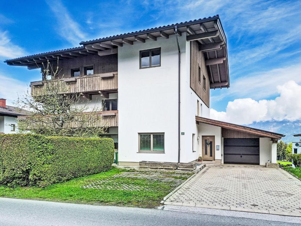 a white house with a black garage at Apartment Schöser by Interhome in Weerberg