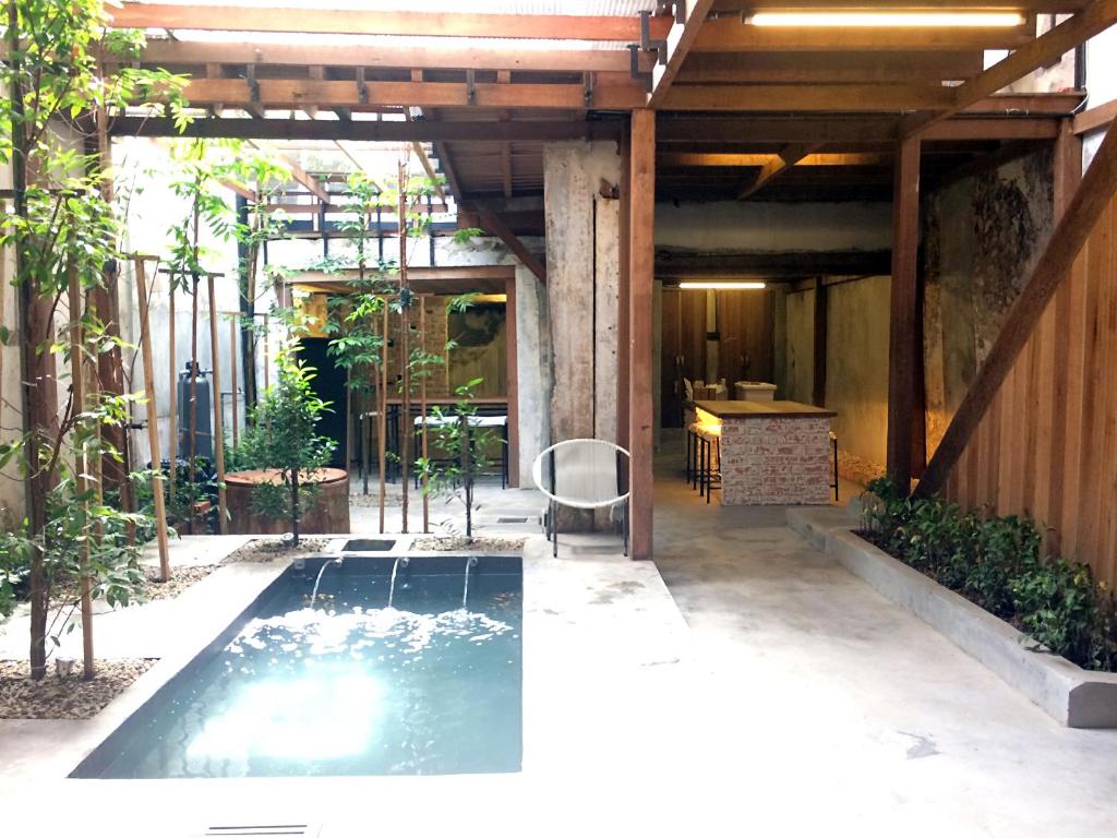 a swimming pool in the middle of a patio at Rimba Hang Kasturi Villa in Melaka
