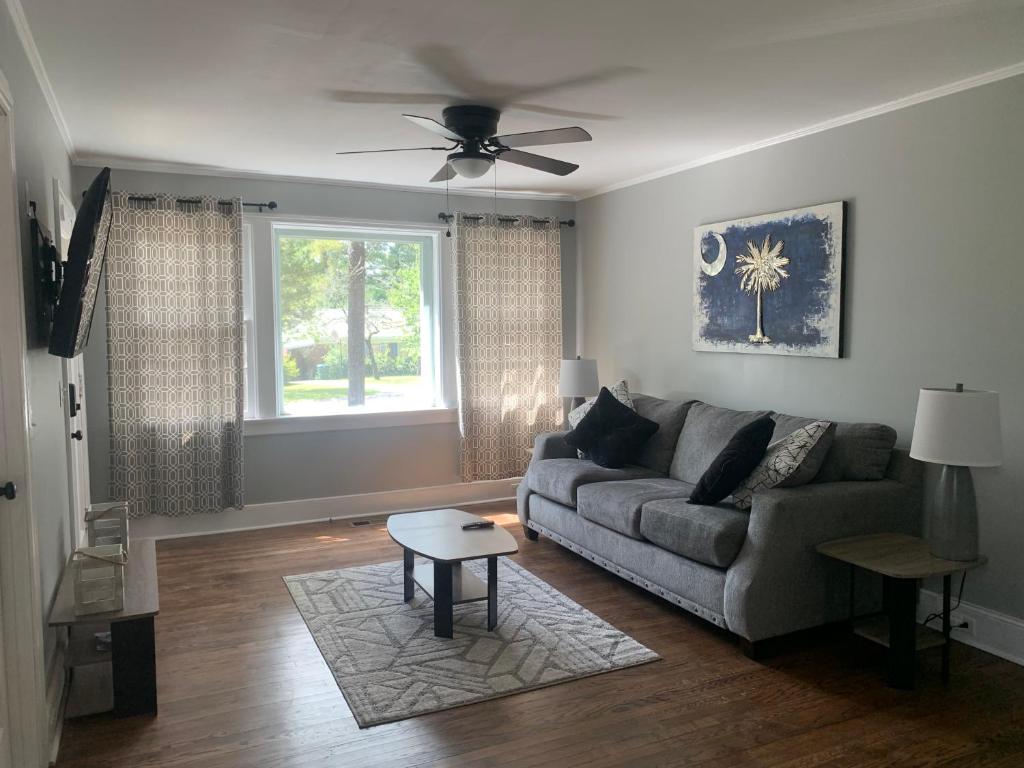 a living room with a couch and a ceiling fan at Cozy Columbia Retreat in Columbia