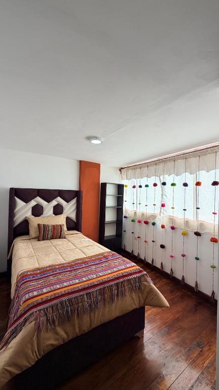 a bedroom with a large bed with lots of storage at Mayupata home in Cusco
