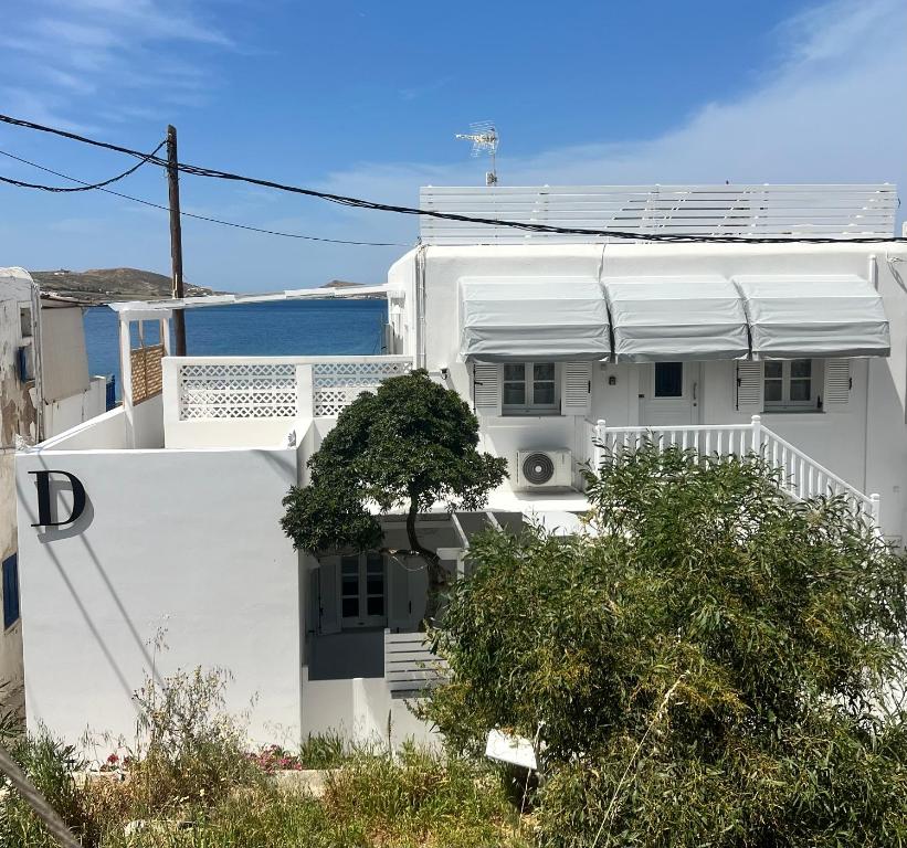 a white house with the ocean in the background at Daphne in Naousa