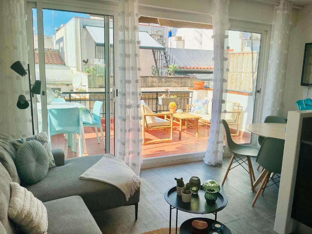 a living room with a couch and a table at Pure Chill Apartment Sitges centre beach in Sitges