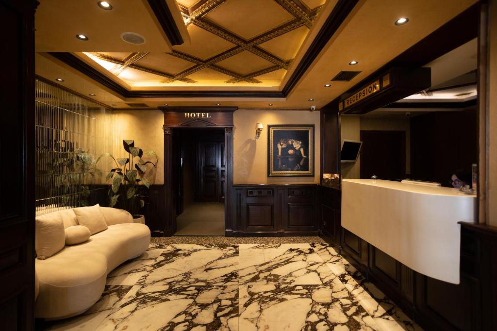 ein großes Badezimmer mit Sofa und Waschbecken in der Unterkunft Hotel Chicago in Shkodra