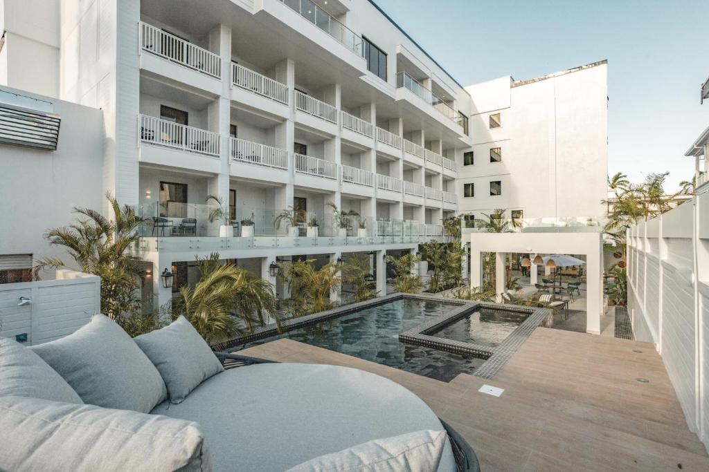 an external view of a hotel with a swimming pool at Fort George Hotel and Spa in Belize City