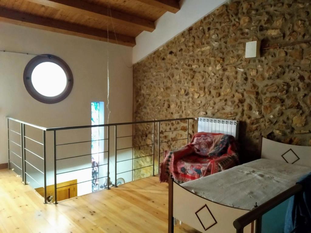 a room with a stone wall and a window at A Ciciredda in Barrafranca