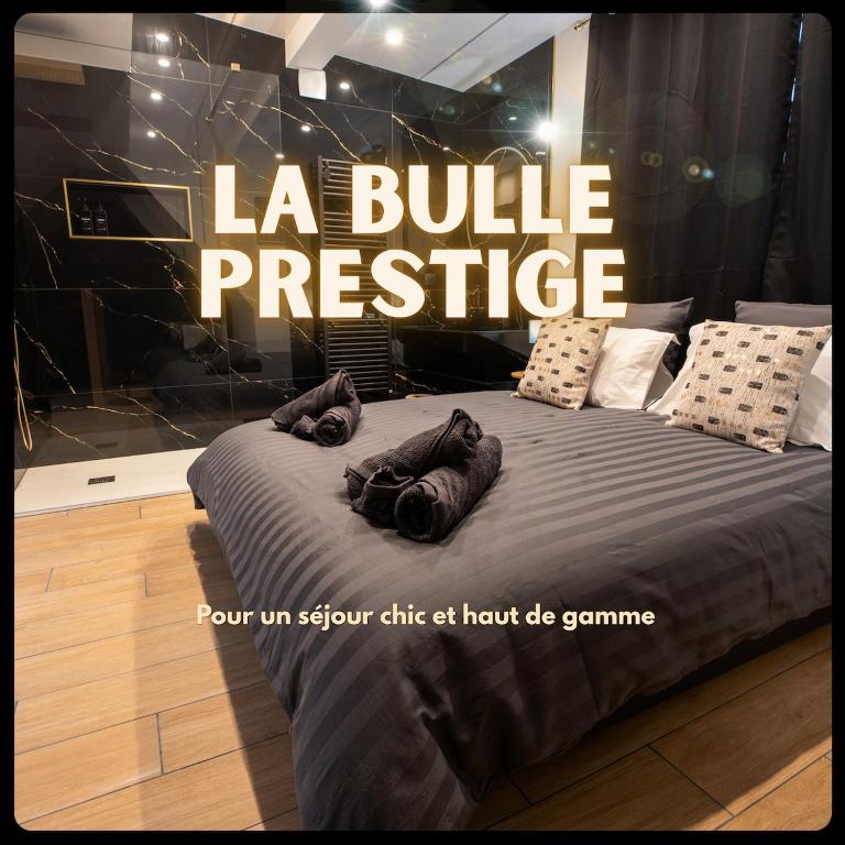 a poster for a store with a bed with pillows at La Bulle Prestige in Montargis