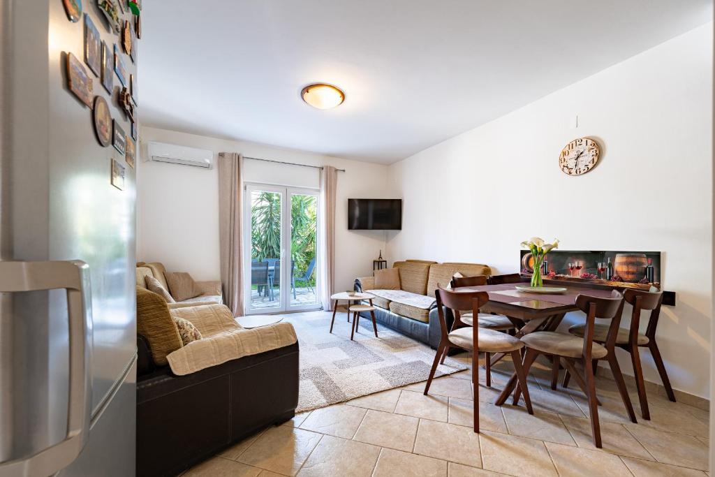 a living room with a table and a dining room at Verde Mar Apartment in Tivat